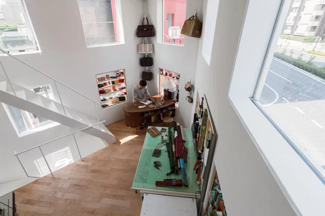 Meanwhile, inside, the ceiling heights get lower, but daylight and views improve as you ascend narrow stairs that lead up from the garage to the atelier.