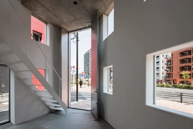 Meanwhile, inside, the ceiling heights get lower, but daylight and views improve as you ascend narrow stairs that lead up from the garage to the atelier.