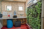 In addition to the clearly visible structure, its teaching tools include a living wall fed by treated graywater.