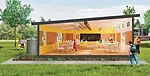 The classroom features clerestory windows to enhance daylighting, exposed ductwork, and a clearly evident flitch beam supporting the roof.