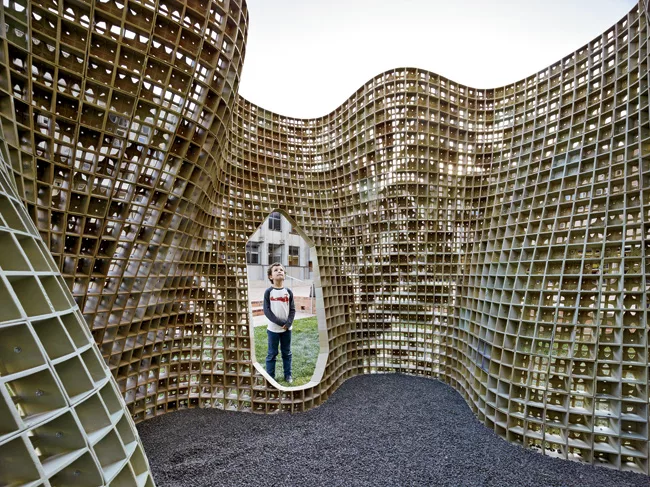 The pavilion, called Bloom, is made up of 840 individual bricks, which form a lacy floral pattern when joined together.