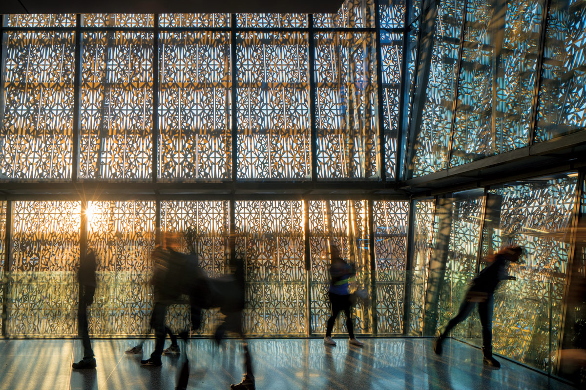 <br><h9>National Museum of African American History and Culture by Adjaye Associates <br>Washington, D.C., photo by Nic Lehoux, 2017</h9><p>   </p><h6><strong>NIC LEHOUX</strong><br>
Photographer based in Seattle<p>   </p>Images are meant to open up a conversation.
For the first 15 years, I shot on 4x5 film, with
complex lighting—hot lights and strobes;
technically, they were very involved shoots. I
still have that in my DNA and apply some of
those techniques in my current work. But
I’ve always had a strong sensitivity to street
photography; some of my heroes are documentary
and war photographers, people who
are looking to capture the soul of the culture
we live in. It was harder to bring these instincts
into 4x5 film work. However, the use
of medium-format digital—I use Arca-Swiss
and Fuji GFX cameras with an assortment of
esoteric German lenses and filters adapted
from the cinema industry—has given me the
freedom to be more exploratory and experimental
in how I approach architecture with
people. At the same time, there’s a new openness
on the part of my clients, who more and
more are willing to have me tell almost a
social story through their buildings.<p>   </p>My compositions are extremely rigorous:
no excessively wide angles, always very concise
one-point perspectives, very sectional
and elevational in composition, and then I
break this rigor visually by mixing in the
theater of people in the public space. It’s
about setting the proper composition and
then waiting for the natural ballet of people
to enter the space at the decisive moment.
Sometimes the shot is done in 30 seconds,
and sometimes it takes 45 minutes. I want to
capture people enthralled by the space, as
well as the subtleties of the space itself. Why
are people captivated? What is magical about
this space? The result is a studied composition
with an incredible natural looseness of
people in the space. We’re lucky to be in an
era where architecture is particularly interesting,
aren’t we?</h6>