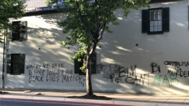 Historic Decatur House with graffiti reading: Why do we have to keep telling you black lives matter?