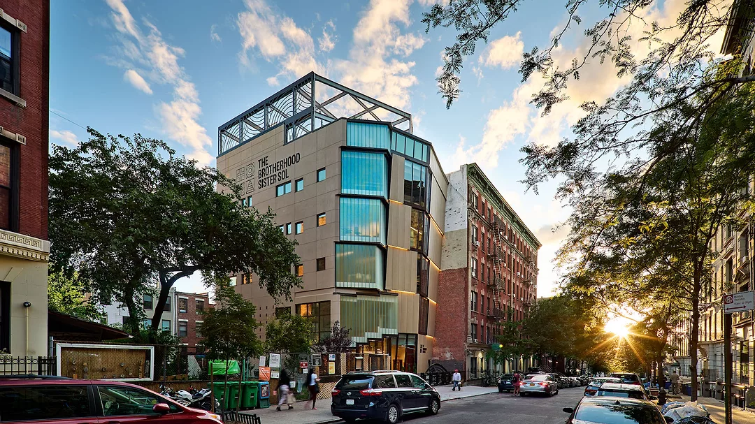 a building with a faceted facade on an nyc street