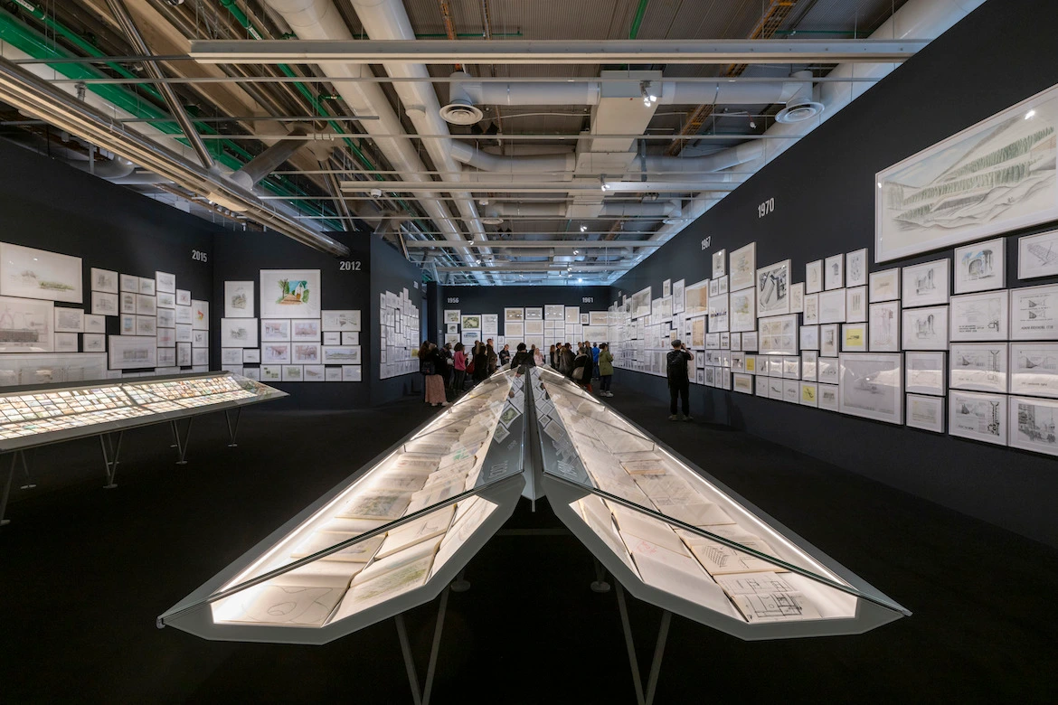 drawings and sections displayed in an architecture exhibition.
