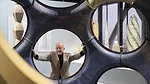 norman foster poses with a fly's eye dome prototype at an exhibition