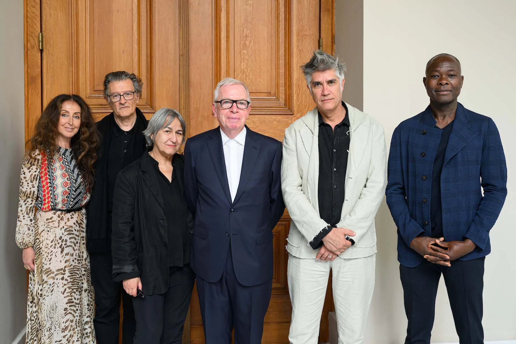 a group photo of pritzker prize officials and laureates.