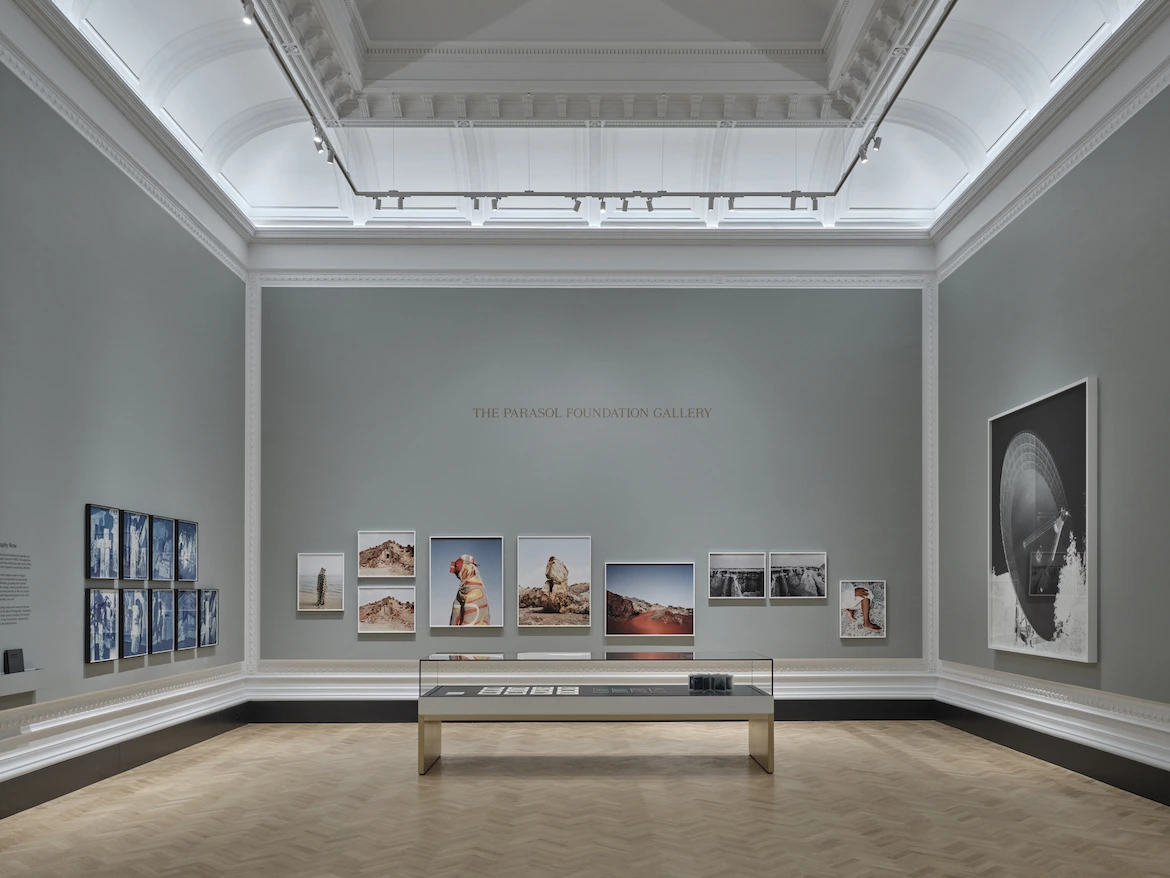 view of a museum gallery with large-scale photographs.