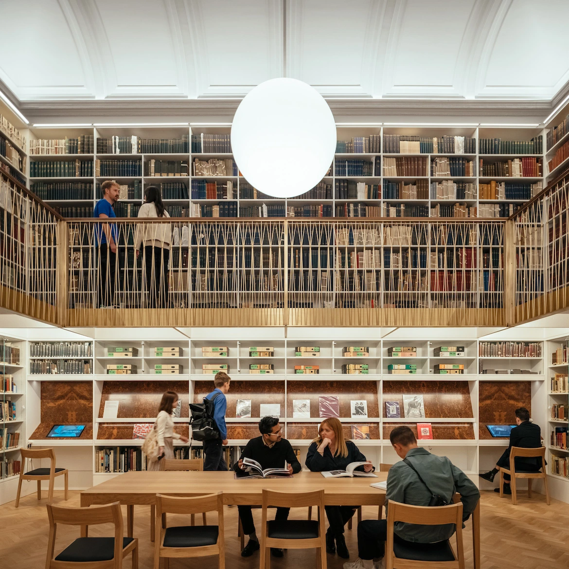 a museum library space with a mezzanine